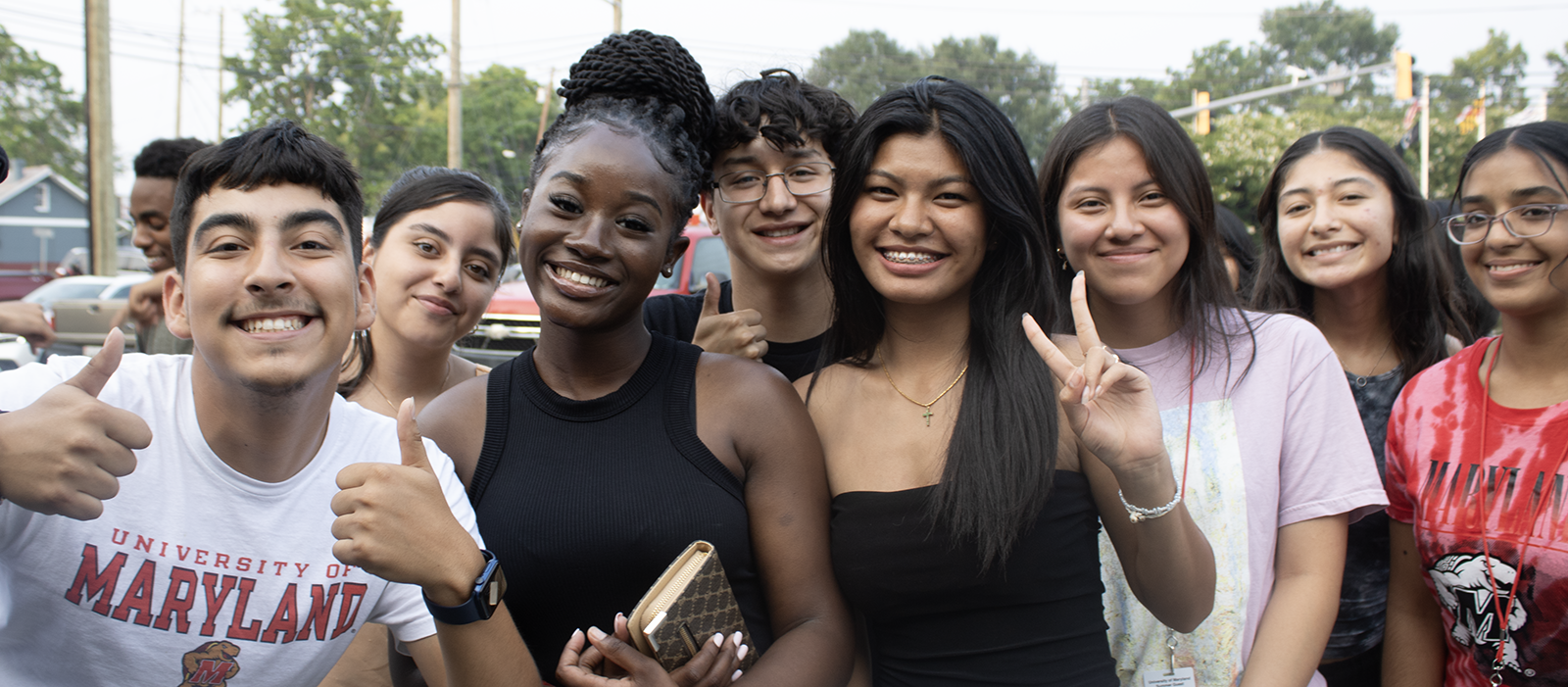 group of students posing with thumbs up
