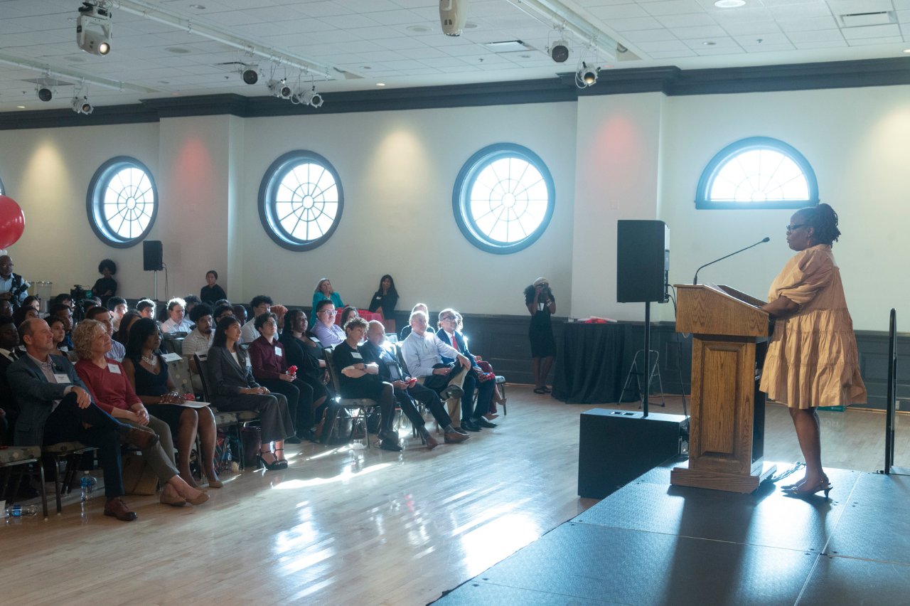 Jackie speaks at podium