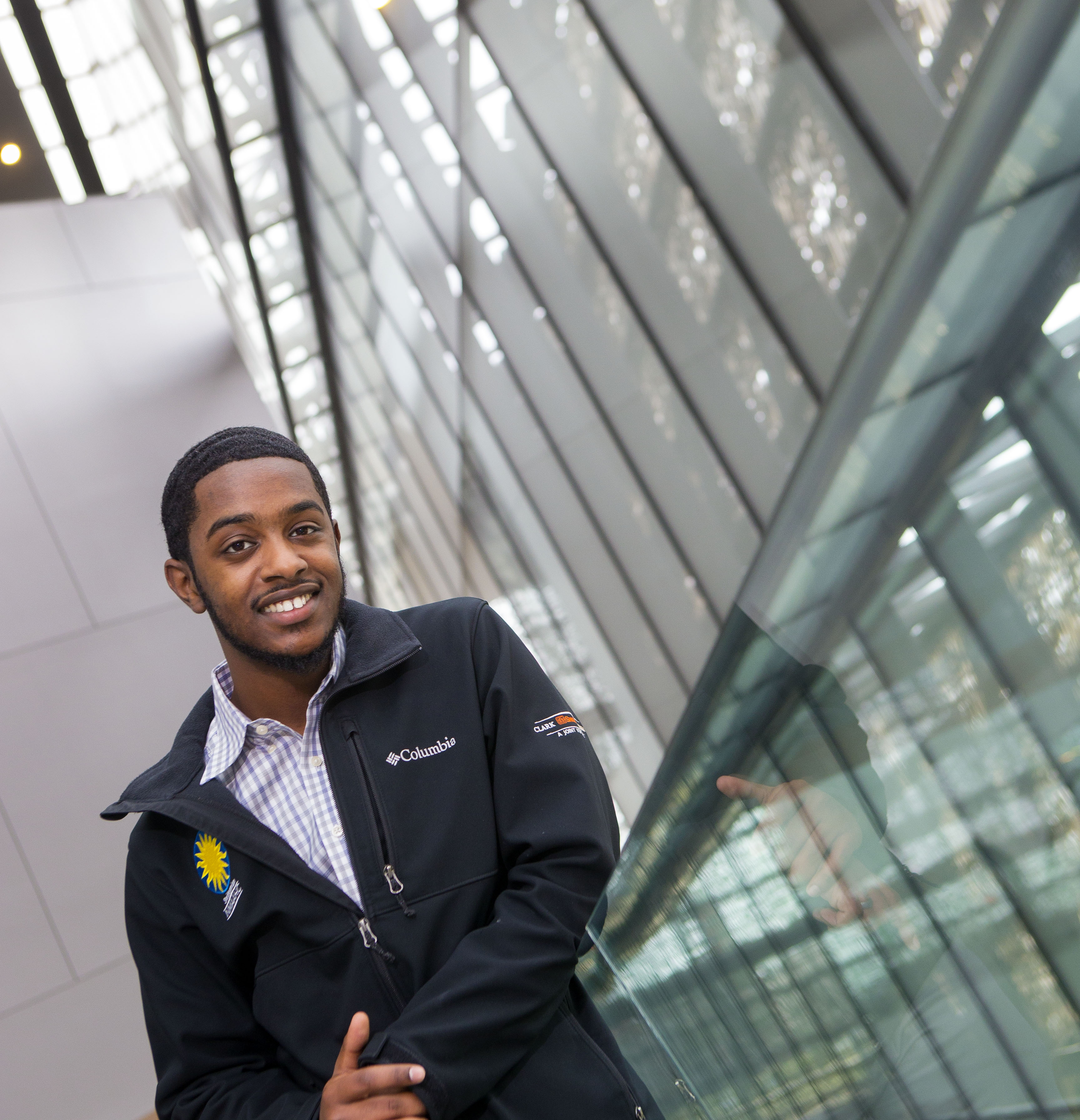 Hamza stands at museum smiling